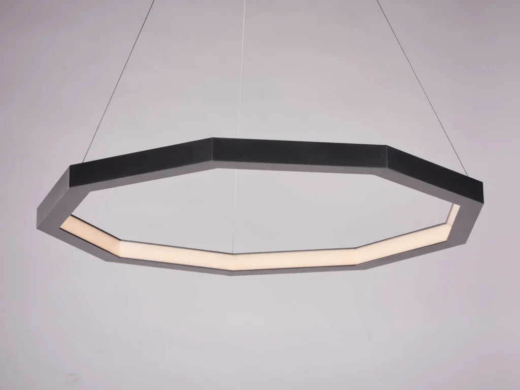 Luxennea Series 2 LED pendant with nine-sided geometric form, faceted aluminum construction, and inward diffused illumination. Designed and manufactured by Karice.