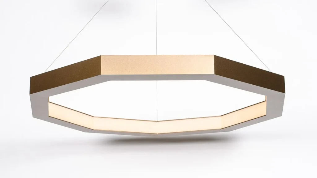 Luxennea enneagon LED pendant with aluminum frame, acrylic diffuser, and custom bronze finish. Designed and manufactured by Karice.