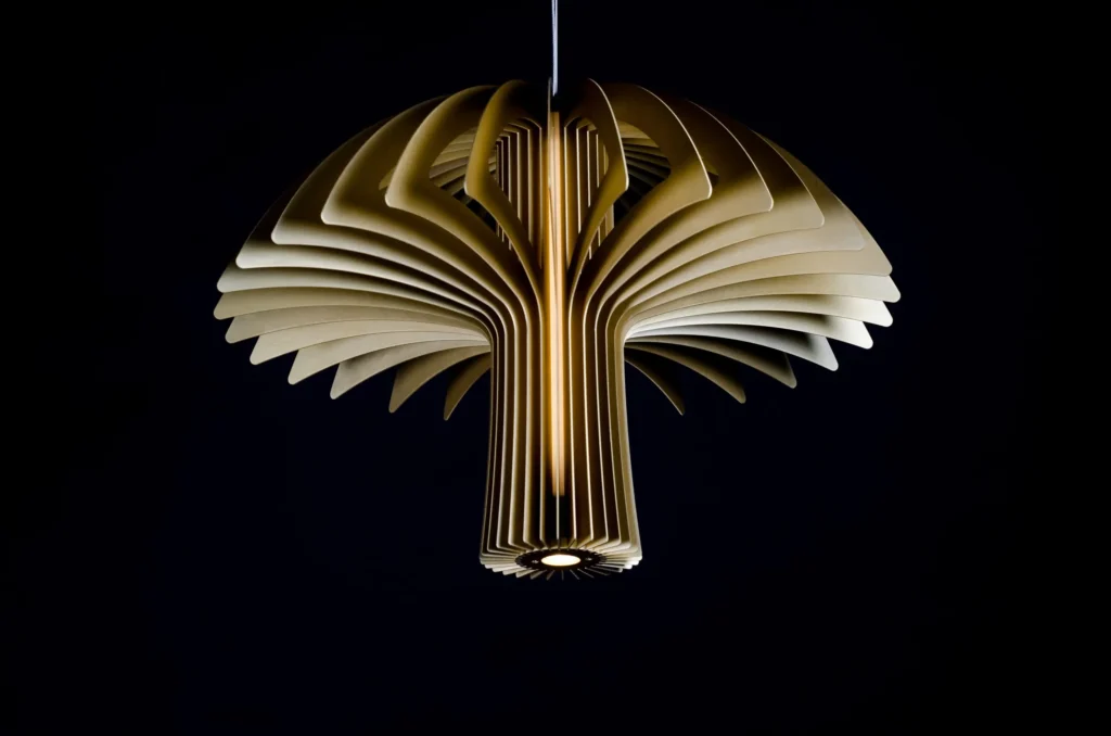 Shroom LED pendant light with mushroom-inspired form, aluminum blade construction, and illuminated acrylic core. Designed and manufactured by Karice.
