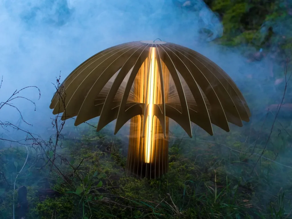 Shroom LED pendant light with mushroom-inspired form, aluminum blade construction, and illuminated acrylic core. Designed and manufactured by Karice.