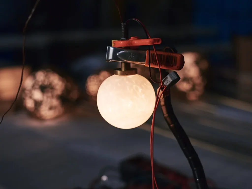 Spheres bronze sculptural light with hand-blown glass globes and dim-to-warm LED technology. Designed and manufactured by Karice, in collaboration with Marie Khouri.