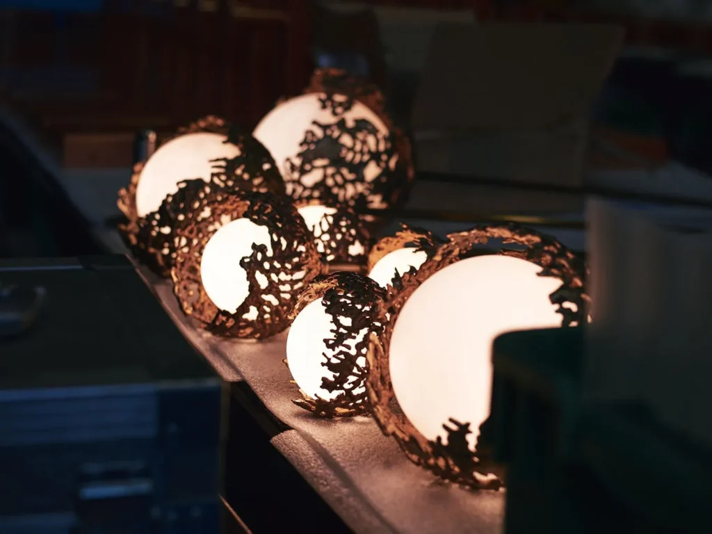 Spheres bronze sculptural light with hand-blown glass globes and dim-to-warm LED technology. Designed and manufactured by Karice, in collaboration with Marie Khouri.