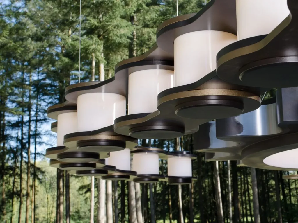 The Sprocket and Chain 10-foot LED chandelier features an oversized gear-and-chain form, suspended by concealed aircraft cables and fasteners. Designed and manufactured by Karice.