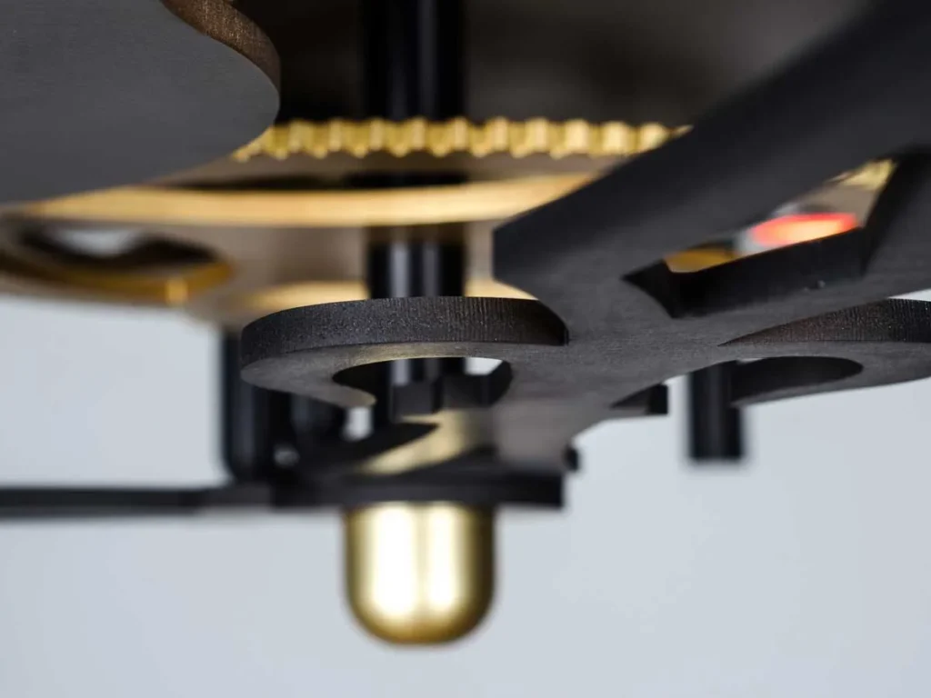 TIME sculptural LED light inspired by clockwork, featuring exposed gears, springs, pins, and ruby-like COB LED lights. Designed and manufactured by Karice.
